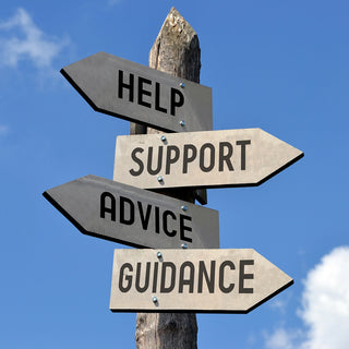 A wooden post in front of a blue sky with clouds has four directional signs attached. The signs, from top to bottom, read "HELP," "SUPPORT," "ADVICE," and "GUIDANCE," each pointing in different directions.