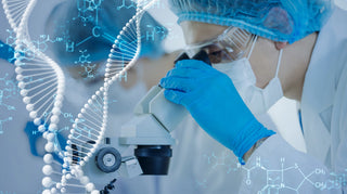 A scientist in a lab coat, gloves, and protective eyewear is looking into a microscope. There is a blue double helix DNA model and chemical formulas overlaid on the image