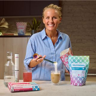 Davinia Taylor in a kitchen preparing a drink with Willpowders products.