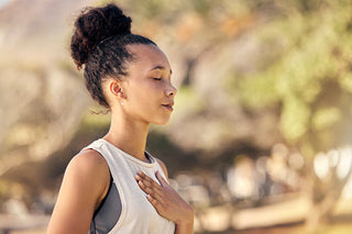 A person breathing on a background featuring blurred natural scenery