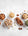 A selection on bowls of activated nuts on a white background