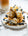 pancakes on a white plate drizzled with yoghurt, blueberries and honey