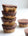 Almond and chocolate cakes stacked on a white background