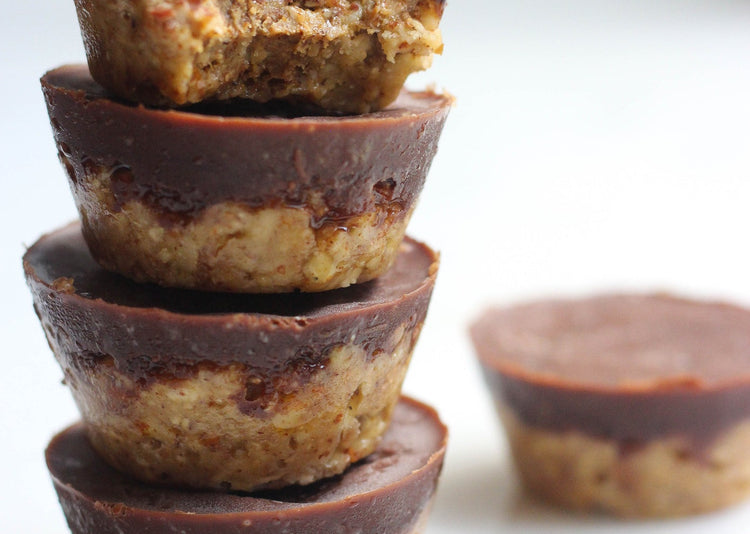 Almond and chocolate cakes stacked on a white background
