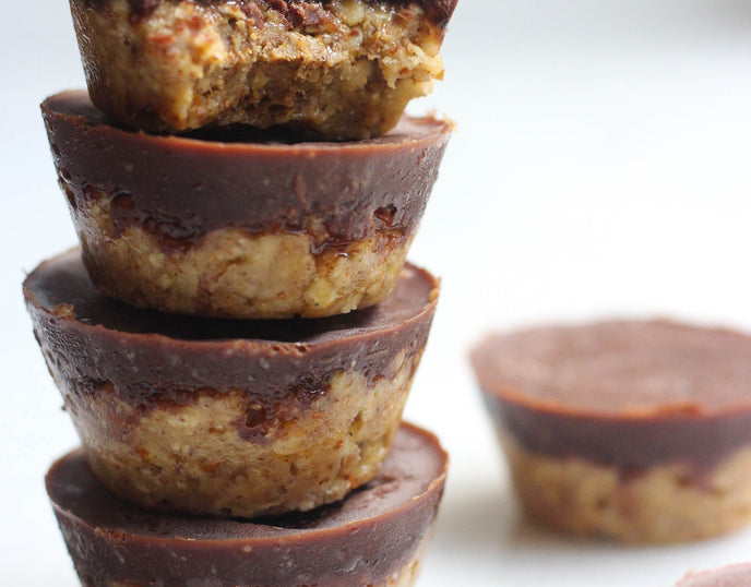 Almond and chocolate cakes stacked on a white background