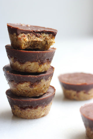 Almond and chocolate cakes stacked on a white background