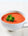 red pepper soup in a white bowl 
