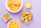 An assortment of snacks on a purple background