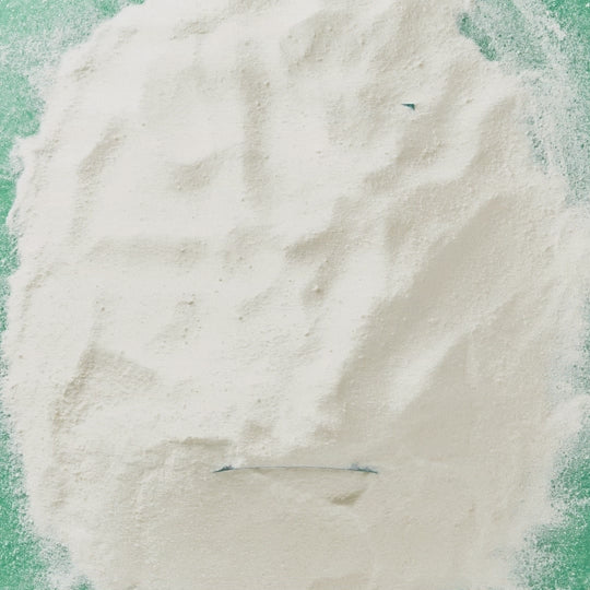 GIF showing a pile of madagascan vanilla with celtic sea salt protein powder being moved aside to reveal the product pouch beneath