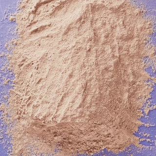 GIF showing a pile of milk chocolate with celtic sea salt protein powder being moved aside to reveal the product pouch beneath