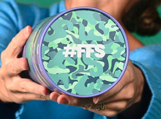 Woman holding a Protein Powder tub showing the lid with the text #FFS