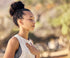 A person breathing on a background featuring blurred natural scenery
