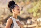 A person breathing on a background featuring blurred natural scenery