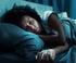 Person sleeping on a blue bed